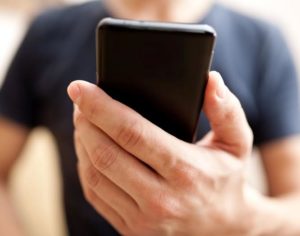 Close up of a man using mobile smart phone