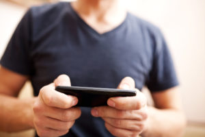 Close up of a man using mobile smart phone