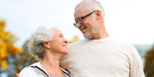 senior couple hugging in city park