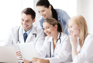 group of doctors looking at tablet pc
