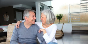Happy senior couple connected on internet at home