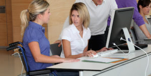 Woman in wheelchair working in the office